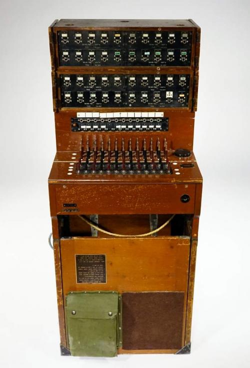 A portable switchboard in a fold-up wooden case.