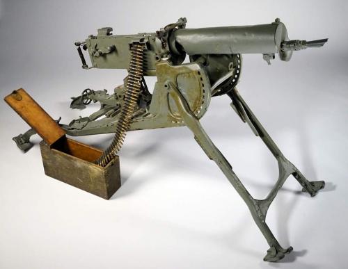 An image of an ammunitions belt  partially loaded into a large machine gun.