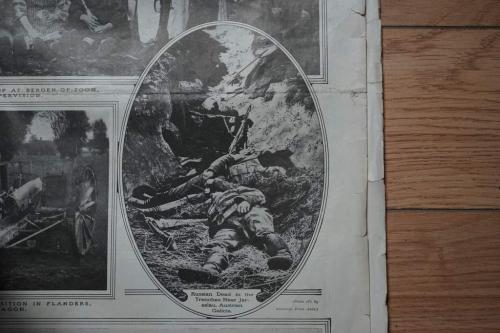 A black-and-white newspaper photograph of several dead Russian soldiers lying in a trench.