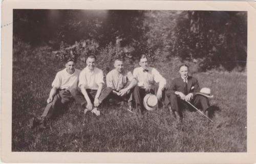 A black-and-white photograph of Byron Cooper Sisler sitting with a group of friends.