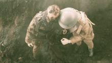 Capture d’écran d’un mannequin-soldat que l’on tire d’un cratère  d’obus de boue.