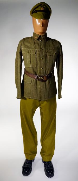 A mannequin wearing a soldier’s green khaki cap and an  undecorated tunic.