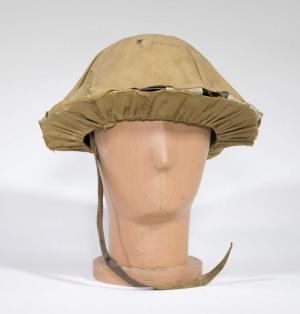 A rounded steel helmet with khaki-coloured canvas covering.