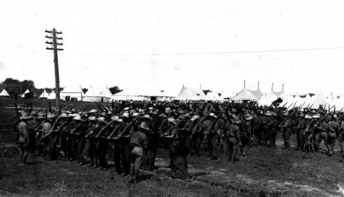 A black and white photograph of a group of soldiers forming up into rows  during training.