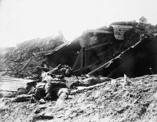 A black-and-white photograph of the bodies of dead German soldiers in a devastated landscape