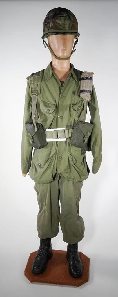 A mannequin wearing an olive-green drab uniform.