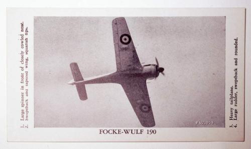 A black-and-white flashcard showing a fighter aircraft with a swastika image on the tail.