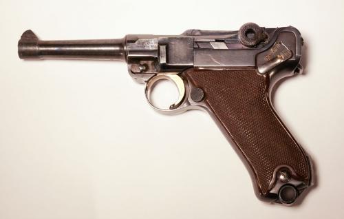 An image of a semi-automatic pistol with a textured, angled grip.