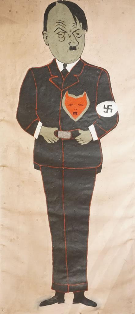 Une grande cible de jeu de fléchettes en toile sur laquelle apparaît une image peinte d’Hitler.