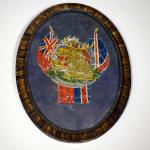 An oval, framed picture with a moose head with Union Jack imagery.