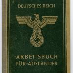 A small, softcover green booklet with the German eagle on top of a swastika  symbol on the cover.