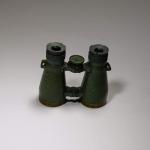 A pair of green metal binoculars.