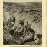 A black-and-white photograph of five soldiers crouched in small holes dug in   the side of a long trench.