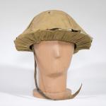 A rounded steel helmet with khaki-coloured canvas covering.
